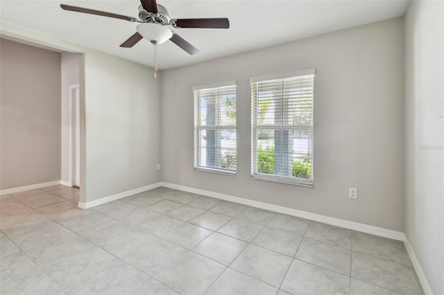 10822 Crushed Grape Dr, Riverview, FL 33578 - unfurnished room with light tile patterned floors, a ceiling fan, and baseboards