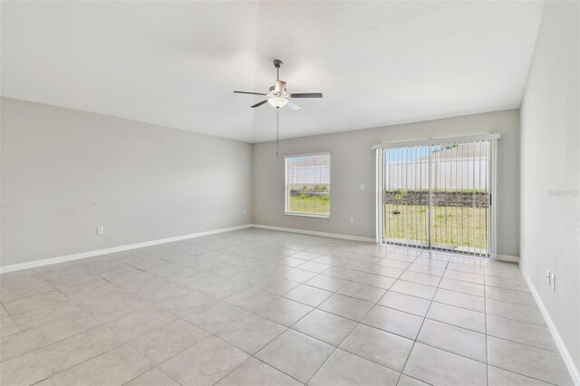 10822 Crushed Grape Dr, Riverview, FL 33578 - spare room featuring ceiling fan, light tile patterned floors, and baseboards