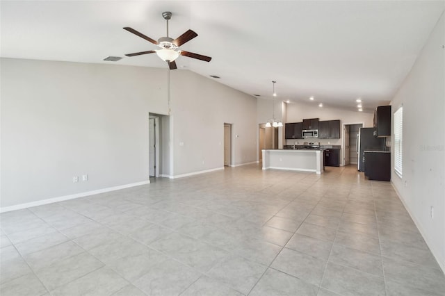 10822 Crushed Grape Dr, Riverview, FL 33578 - unfurnished living room featuring ceiling fan, high vaulted ceiling, a chandelier, baseboards, and light tile patterned flooring