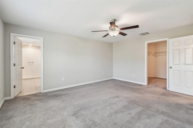 10822 Crushed Grape Dr, Riverview, FL 33578 - unfurnished bedroom featuring carpet flooring, a spacious closet, baseboards, a closet, and connected bathroom