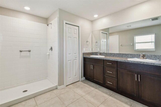 10822 Crushed Grape Dr, Riverview, FL 33578 - bathroom with tile patterned flooring, double vanity, tiled shower, a closet, and recessed lighting
