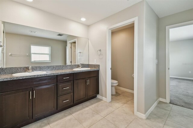 10822 Crushed Grape Dr, Riverview, FL 33578 - full bathroom with toilet, double vanity, tile patterned floors, baseboards, and recessed lighting