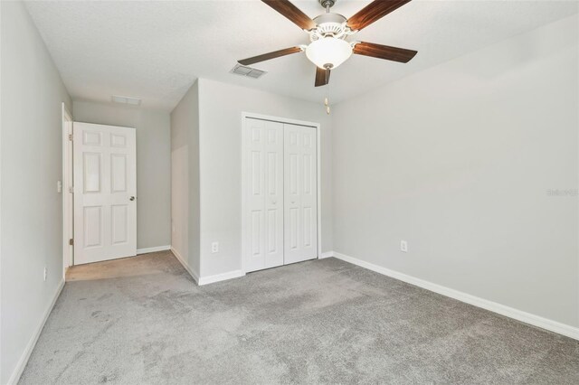 10822 Crushed Grape Dr, Riverview, FL 33578 - unfurnished bedroom featuring carpet, baseboards, a closet, and ceiling fan