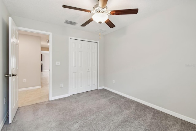 10822 Crushed Grape Dr, Riverview, FL 33578 - unfurnished bedroom featuring carpet floors, a closet, baseboards, and a ceiling fan