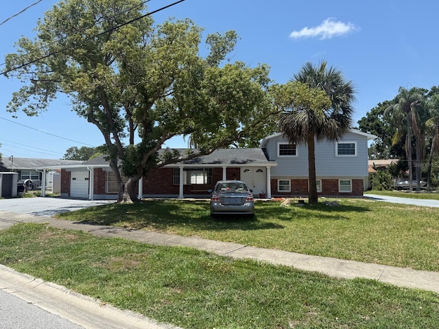4802 Bay Crest Dr, Tampa, FL 33615 - tri-level home with brick siding, a front lawn, driveway, and a porch