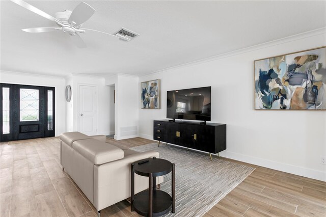 7060 S Shore Dr S, South Pasadena, FL 33707 - living room with ornamental molding, light wood finished floors, baseboards, and ceiling fan