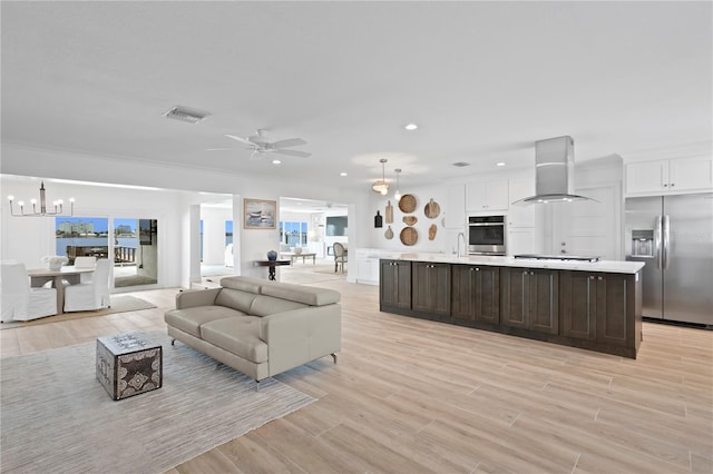 7060 S Shore Dr S, South Pasadena, FL 33707 - living room with a chandelier, a ceiling fan, light wood-style flooring, and recessed lighting