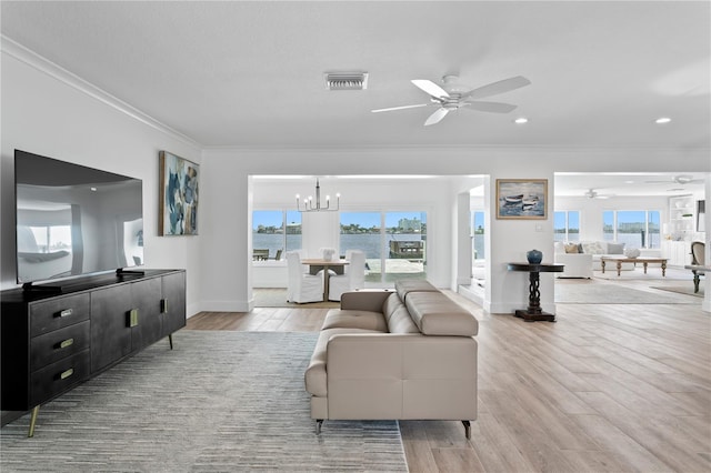 7060 S Shore Dr S, South Pasadena, FL 33707 - living area featuring ceiling fan, crown molding, a chandelier, baseboards, and light wood-style floors