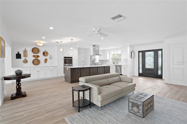 7060 S Shore Dr S, South Pasadena, FL 33707 - living area with crown molding, light wood-type flooring, recessed lighting, and ceiling fan