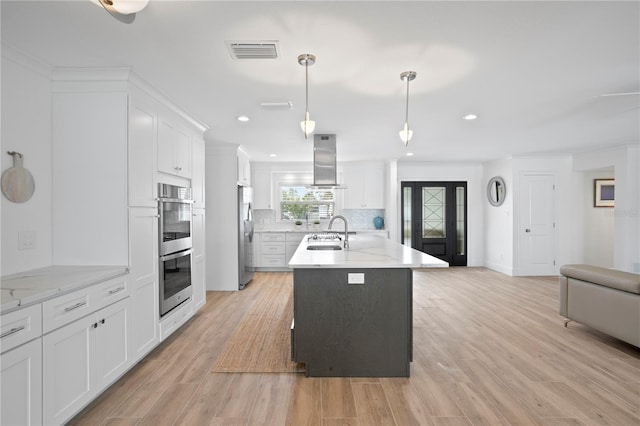 7060 S Shore Dr S, South Pasadena, FL 33707 - kitchen featuring appliances with stainless steel finishes, a sink, exhaust hood, decorative backsplash, and white cabinetry