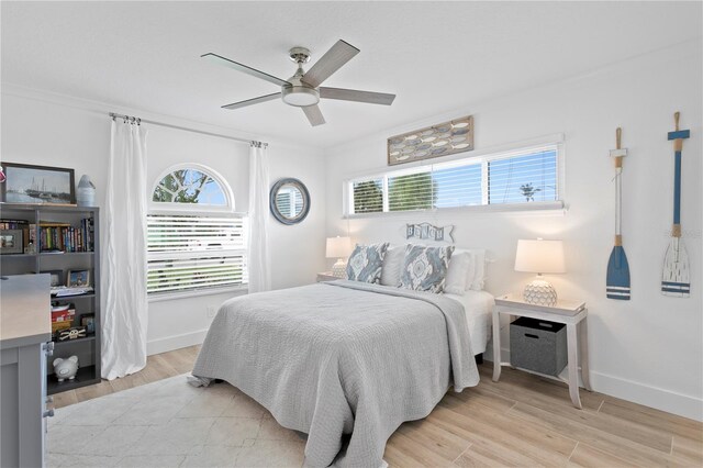 7060 S Shore Dr S, South Pasadena, FL 33707 - bedroom featuring baseboards, light wood-style floors, and ceiling fan