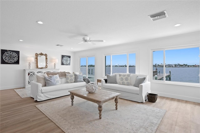 7060 S Shore Dr S, South Pasadena, FL 33707 - living area featuring ceiling fan, wood finished floors, baseboards, recessed lighting, and a water view