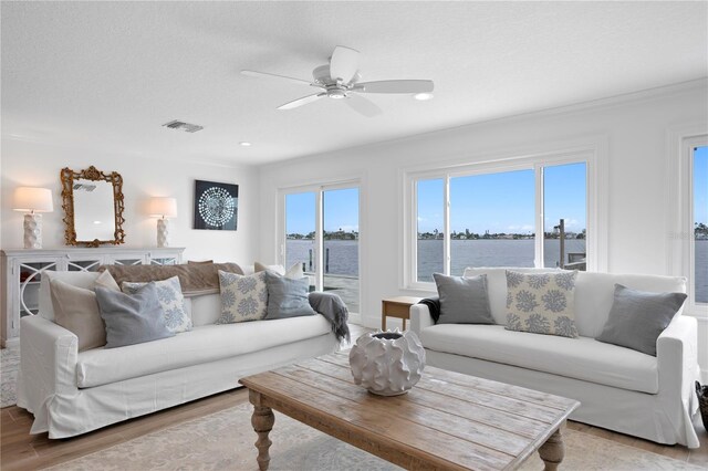 7060 S Shore Dr S, South Pasadena, FL 33707 - living room with a ceiling fan, light wood-style flooring, a water view, and recessed lighting