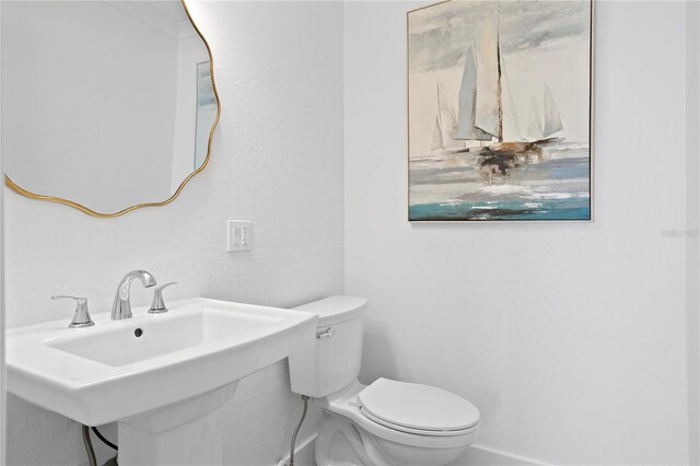 7060 S Shore Dr S, South Pasadena, FL 33707 - half bathroom featuring toilet, a sink, and a textured wall