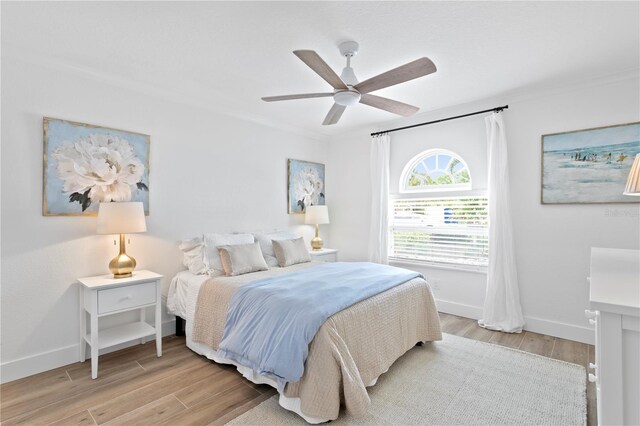 7060 S Shore Dr S, South Pasadena, FL 33707 - bedroom with light wood-type flooring, baseboards, and ceiling fan