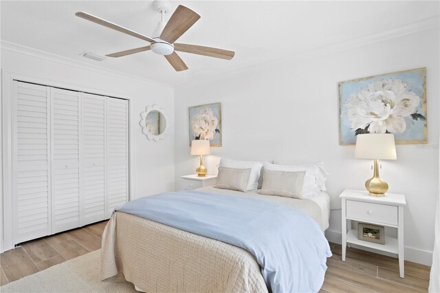 7060 S Shore Dr S, South Pasadena, FL 33707 - bedroom with crown molding, wood finished floors, a closet, and a ceiling fan