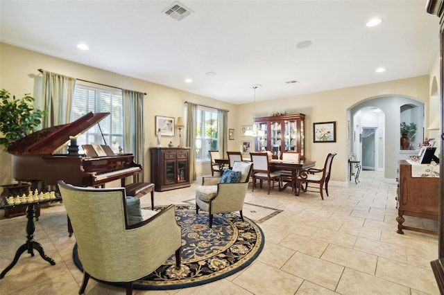 1116 Hillandale Reserve Dr, Tampa, FL 33613 - sitting room featuring arched walkways, recessed lighting, light tile patterned floors, and baseboards