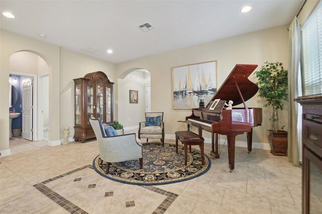 1116 Hillandale Reserve Dr, Tampa, FL 33613 - sitting room with arched walkways, baseboards, recessed lighting, and light tile patterned floors