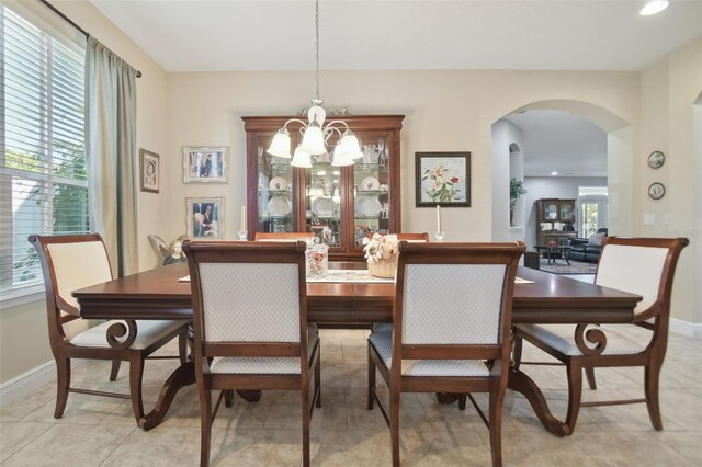 1116 Hillandale Reserve Dr, Tampa, FL 33613 - dining space with arched walkways, a chandelier, baseboards, and recessed lighting