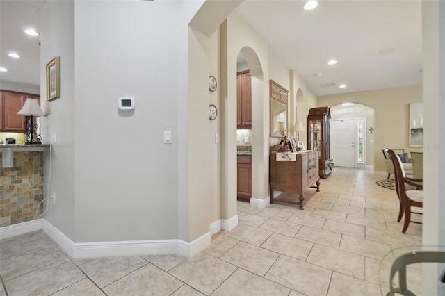 1116 Hillandale Reserve Dr, Tampa, FL 33613 - hall featuring arched walkways, recessed lighting, light tile patterned flooring, and baseboards