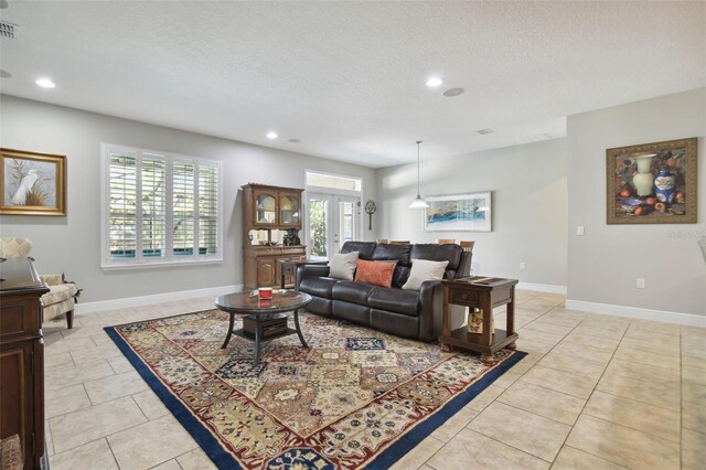 1116 Hillandale Reserve Dr, Tampa, FL 33613 - living room featuring recessed lighting, light tile patterned floors, a textured ceiling, and baseboards