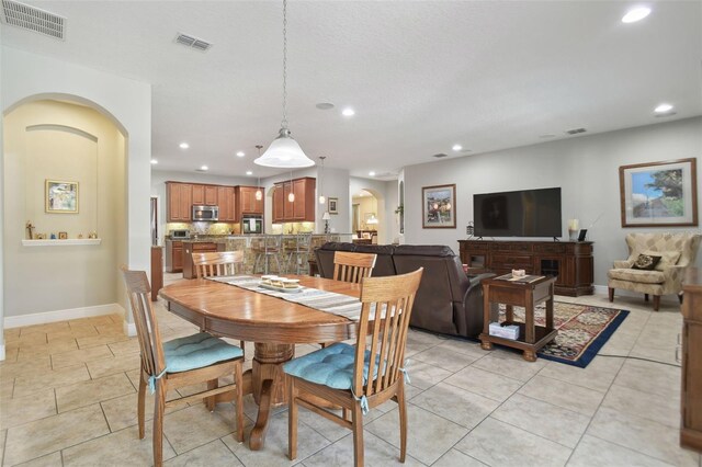 1116 Hillandale Reserve Dr, Tampa, FL 33613 - dining space featuring recessed lighting, baseboards, light tile patterned floors, and arched walkways