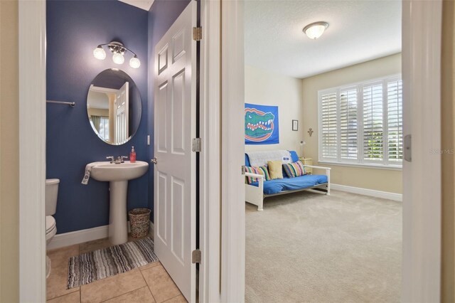1116 Hillandale Reserve Dr, Tampa, FL 33613 - bathroom with toilet, baseboards, and tile patterned flooring