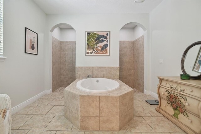 1116 Hillandale Reserve Dr, Tampa, FL 33613 - bathroom featuring a bath, tile patterned floors, baseboards, and a walk in shower