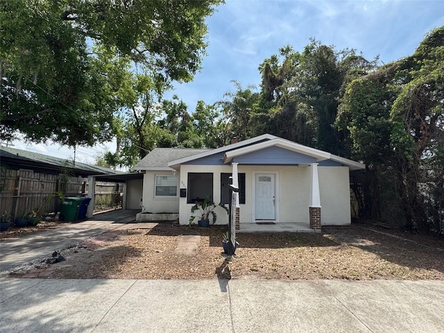 807 E Elm St, Tampa, FL 33604 - view of front of house featuring an attached carport, concrete driveway, and a porch