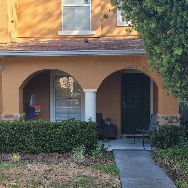 10850 Lake Saint Charles Blvd, Riverview, FL 33578 - entrance to property featuring stucco siding, covered porch, and a shingled roof