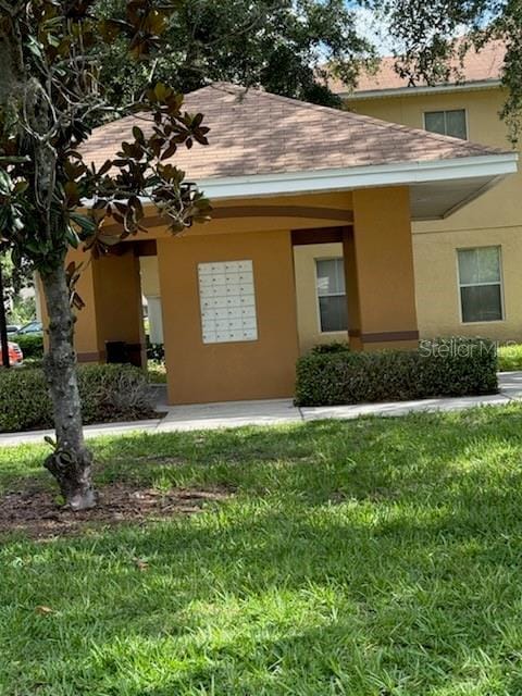 10850 Lake Saint Charles Blvd, Riverview, FL 33578 - view of home's exterior featuring mail area, stucco siding, and roof with shingles
