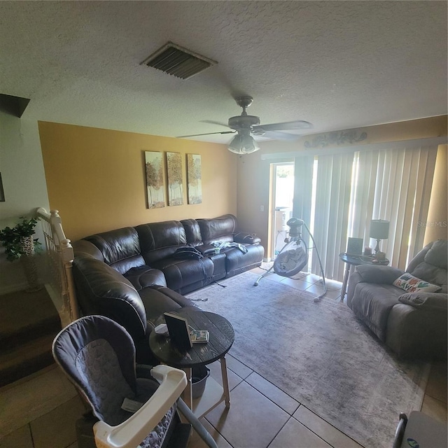 10850 Lake Saint Charles Blvd, Riverview, FL 33578 - living area featuring tile patterned floors, a ceiling fan, and a textured ceiling