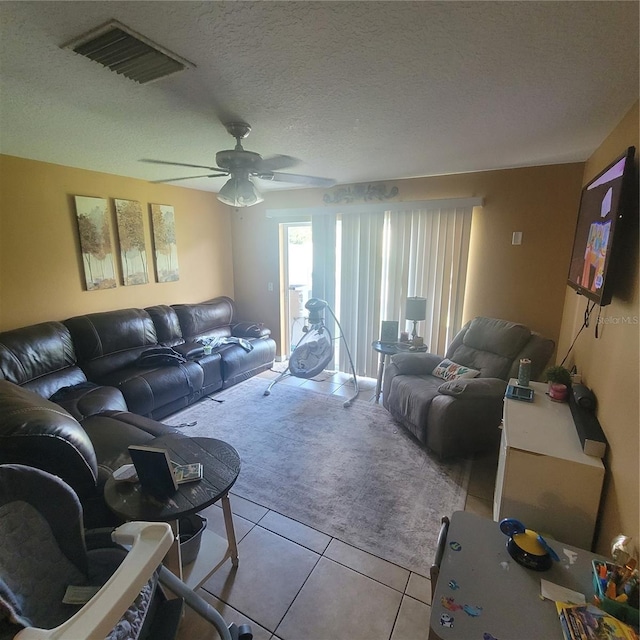 10850 Lake Saint Charles Blvd, Riverview, FL 33578 - tiled living area with carpet flooring, a ceiling fan, and a textured ceiling