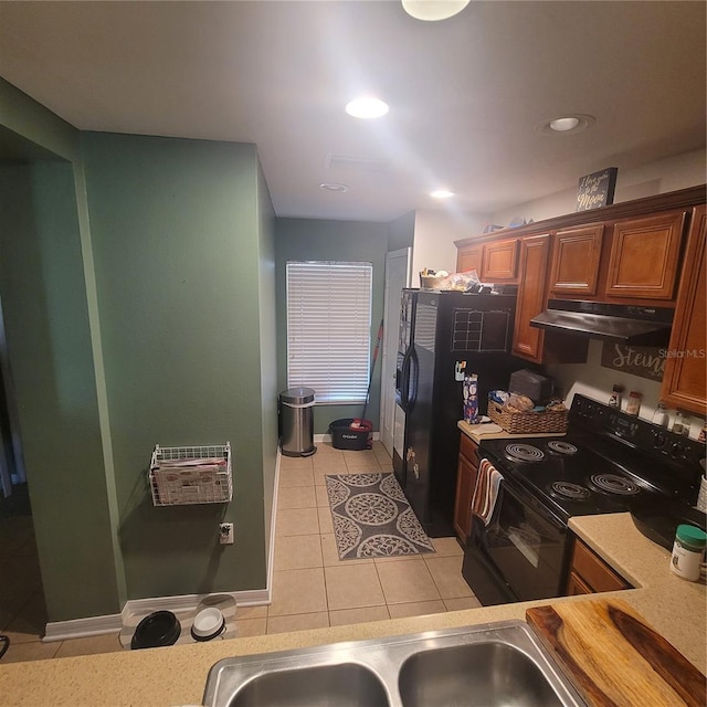 10850 Lake Saint Charles Blvd, Riverview, FL 33578 - kitchen featuring black range with electric cooktop, under cabinet range hood, light tile patterned flooring, light countertops, and recessed lighting
