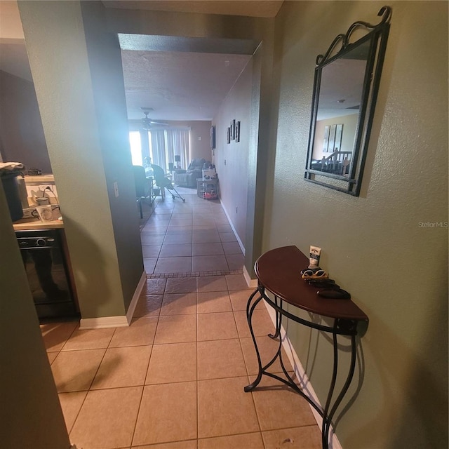 10850 Lake Saint Charles Blvd, Riverview, FL 33578 - hallway with light tile patterned flooring and a textured wall