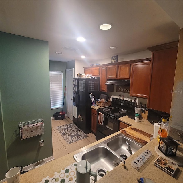 10850 Lake Saint Charles Blvd, Riverview, FL 33578 - kitchen with black appliances, light countertops, under cabinet range hood, light tile patterned floors, and recessed lighting
