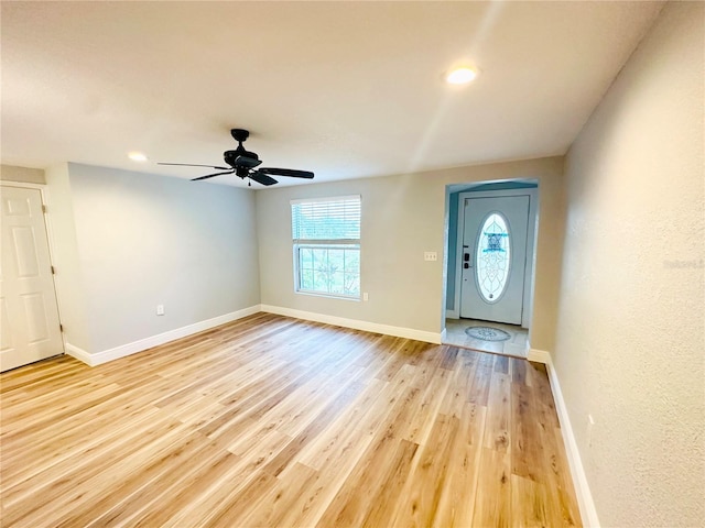 entrance foyer with plenty of natural light, baseboards, light wood-style flooring, and recessed lighting