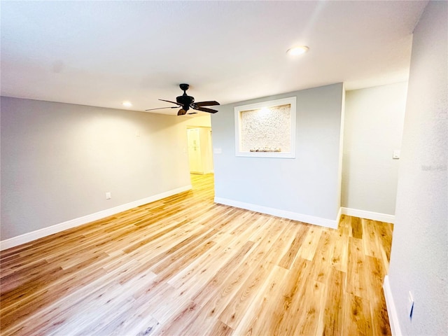 empty room featuring ceiling fan, light wood-style flooring, baseboards, and recessed lighting