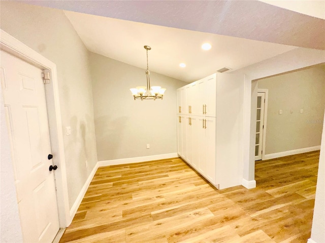 unfurnished dining area featuring a chandelier, light wood finished floors, lofted ceiling, recessed lighting, and baseboards