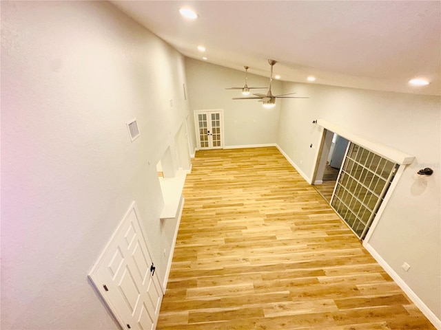 hall featuring recessed lighting, lofted ceiling, baseboards, and light wood-type flooring