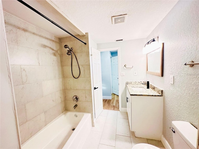 full bathroom with shower / washtub combination, a textured ceiling, vanity, toilet, and tile patterned floors
