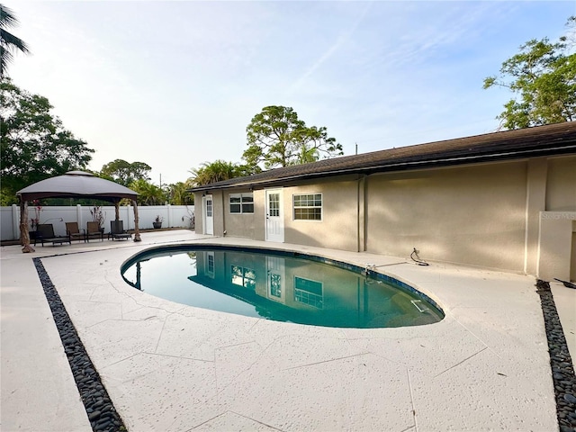 view of swimming pool featuring a gazebo, a patio area, and fence