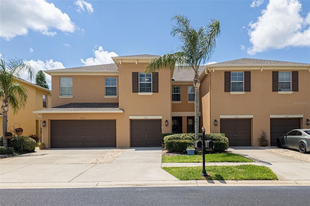 9520 Trumpet Vine Loop, Trinity, FL 34655 - multi unit property featuring an attached garage, stucco siding, and driveway