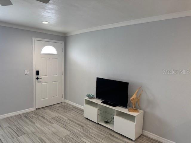 foyer with baseboards, ceiling fan, light wood-type flooring, ornamental molding, and recessed lighting