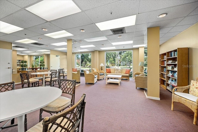 dining room with carpet and a drop ceiling