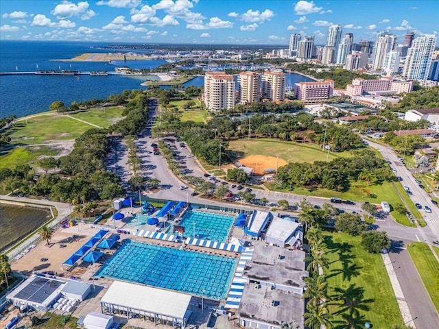aerial view of property and surrounding area with a nearby body of water and a view of skyline