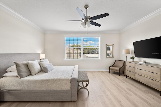 bedroom featuring crown molding, light wood finished floors, baseboards, and a ceiling fan