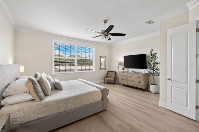 bedroom with crown molding, light wood-style floors, baseboards, and a ceiling fan