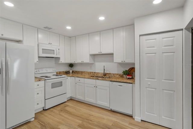 3923 Shoreside Cir, Tampa, FL 33624 - kitchen with white appliances, a sink, white cabinetry, light wood-type flooring, and recessed lighting