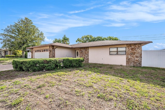 8744 Andros Ln, Port Richey, FL 34668 - ranch-style home featuring an attached garage, stone siding, and stucco siding